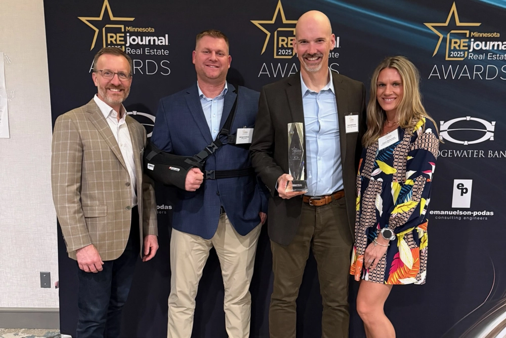 group of men and women holding awards